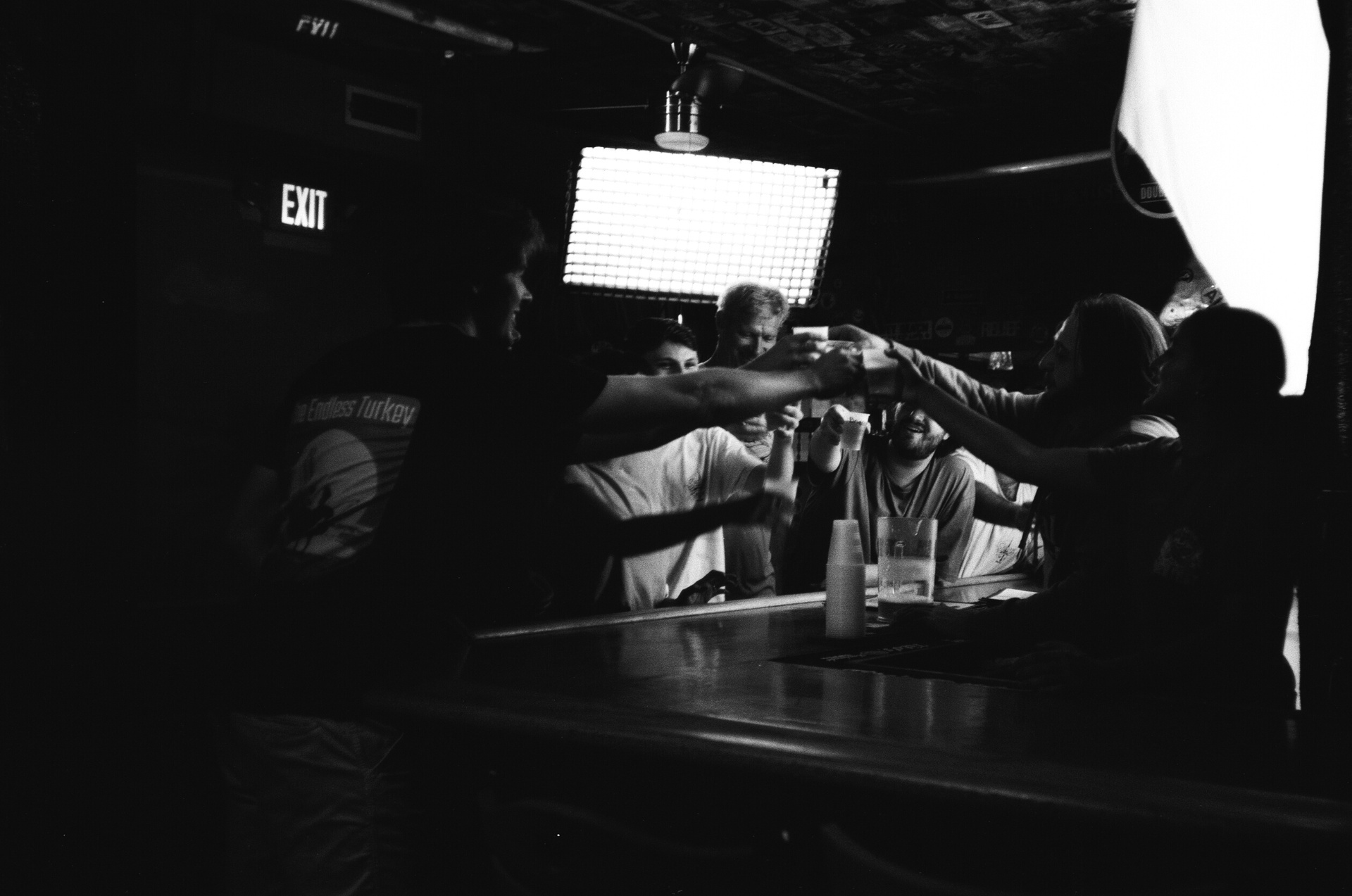 Behind the scenes — black and white shot of a toast inside the bar